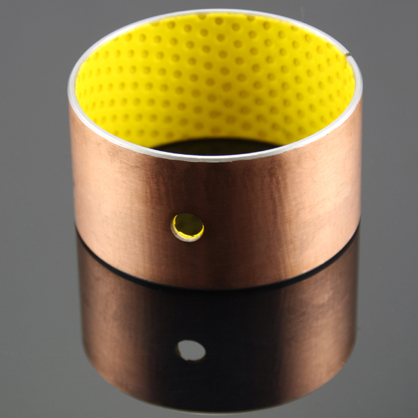 In addition to graphite particles, what other solid lubricants can be embedded in self-lubricating copper bushes?